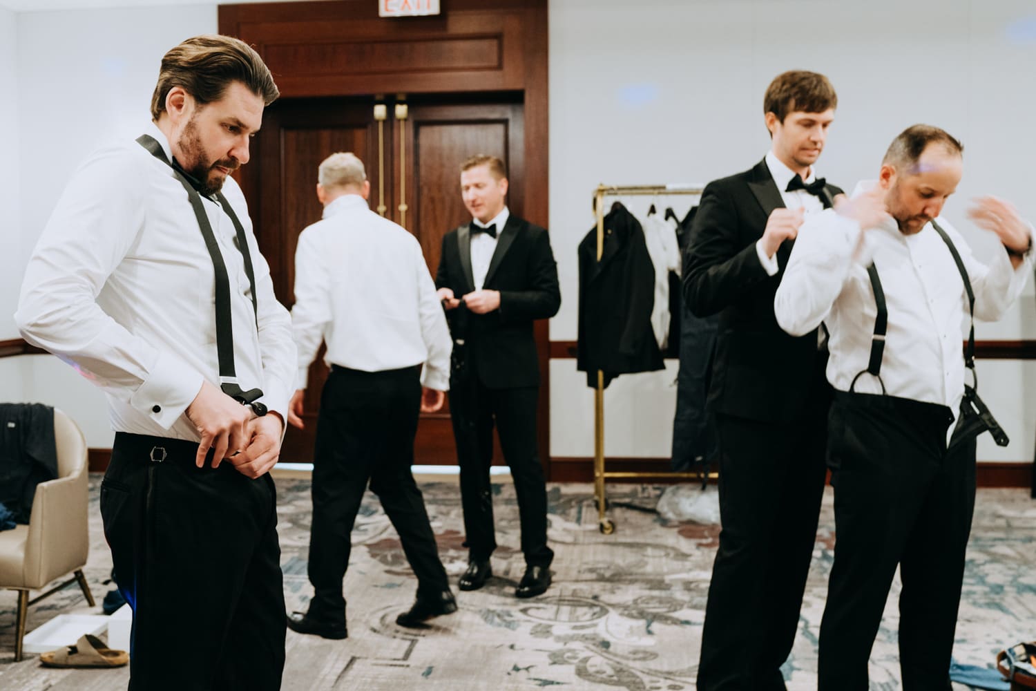 Groom getting ready with groomsmen in a Palace Hotel San Francisco hotel room