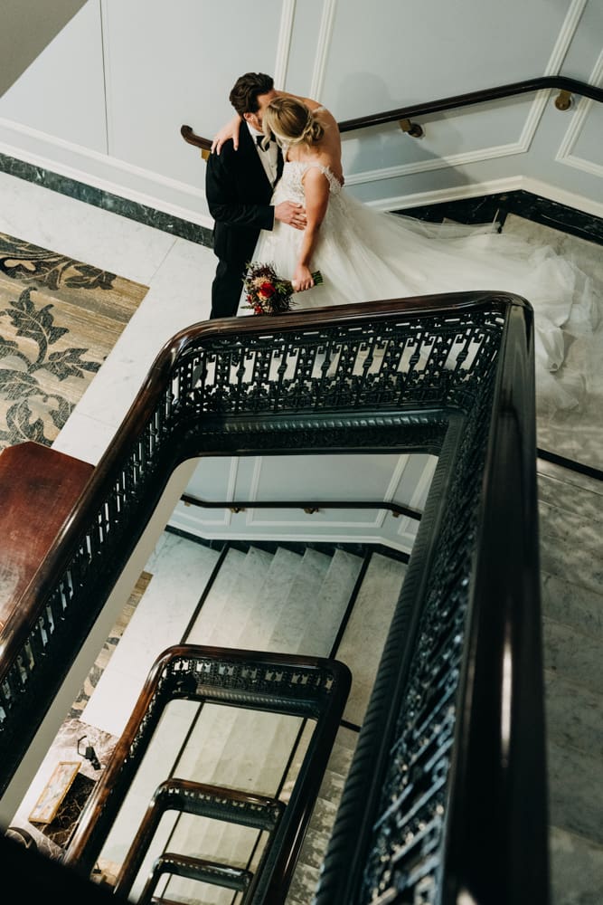 Emotional first look moment on the staircase at the Palace Hotel San Francisco