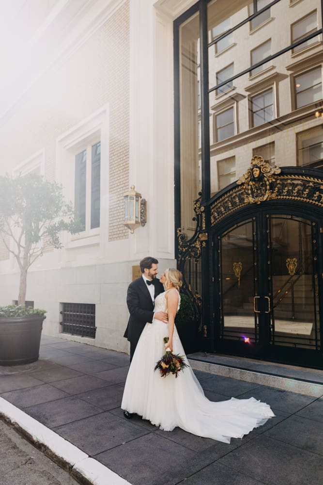 Wedding portrait in front of the historic Palace Hotel San Francisco entrance