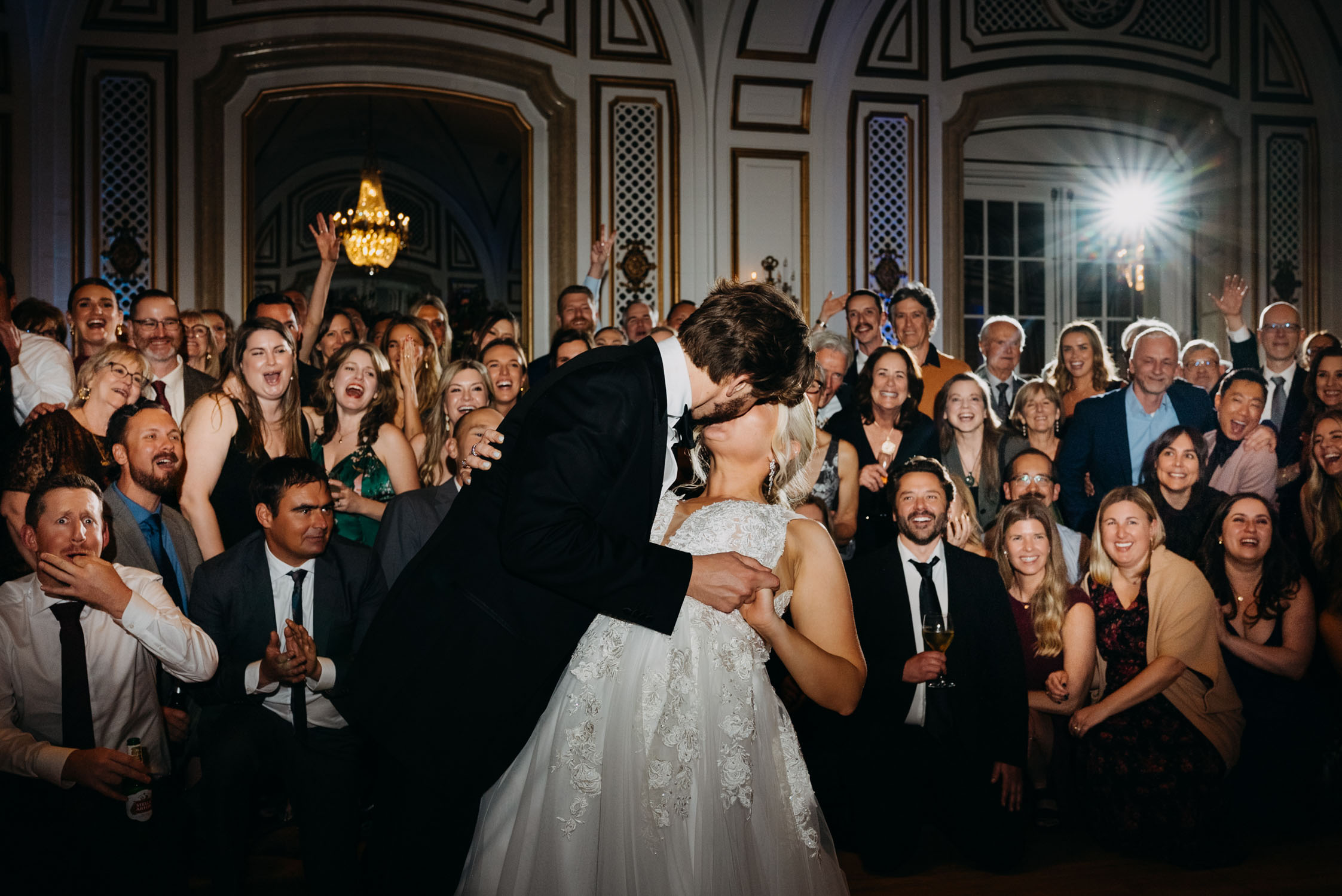 Couple standing in front of wedding guests on dance floor at Palace Hotel San Francisco creating an editorial group photo