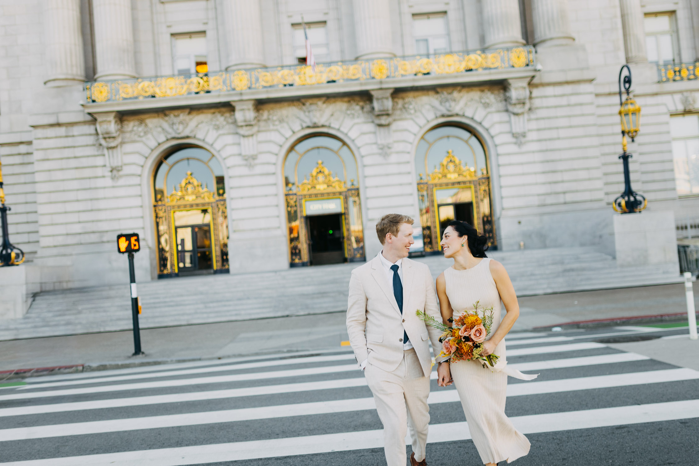couple crossing street City Hall wedding San Francisco