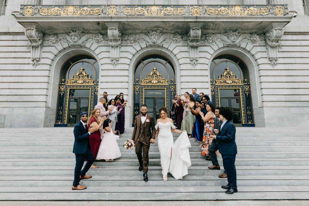 family cheering on front steps City Hall wedding
