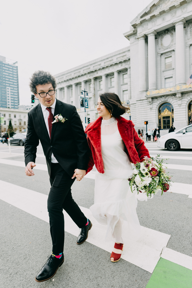 couple crossing street City Hall wedding San Francisco