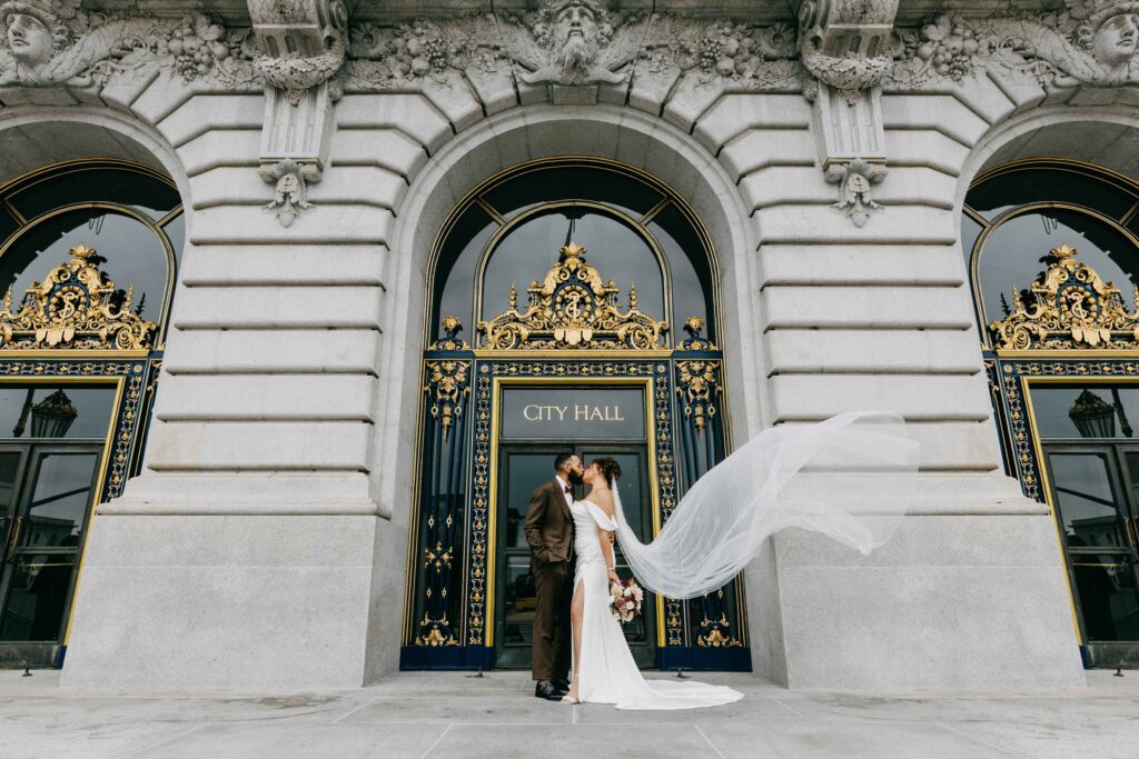 couple exiting City Hall wedding front steps