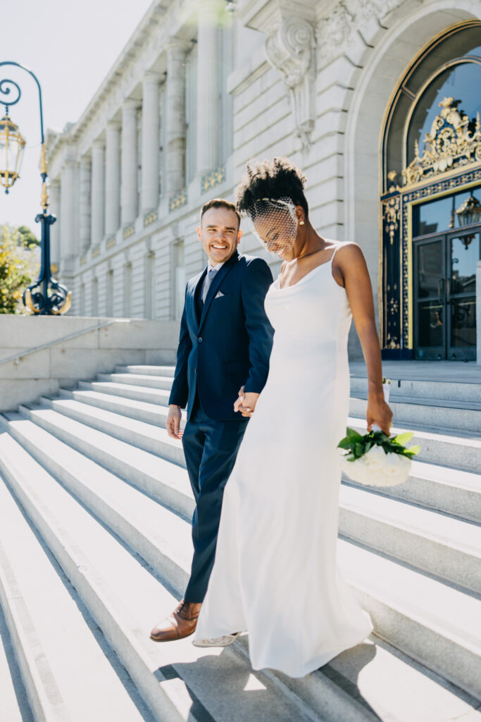 couple exiting City Hall wedding front steps