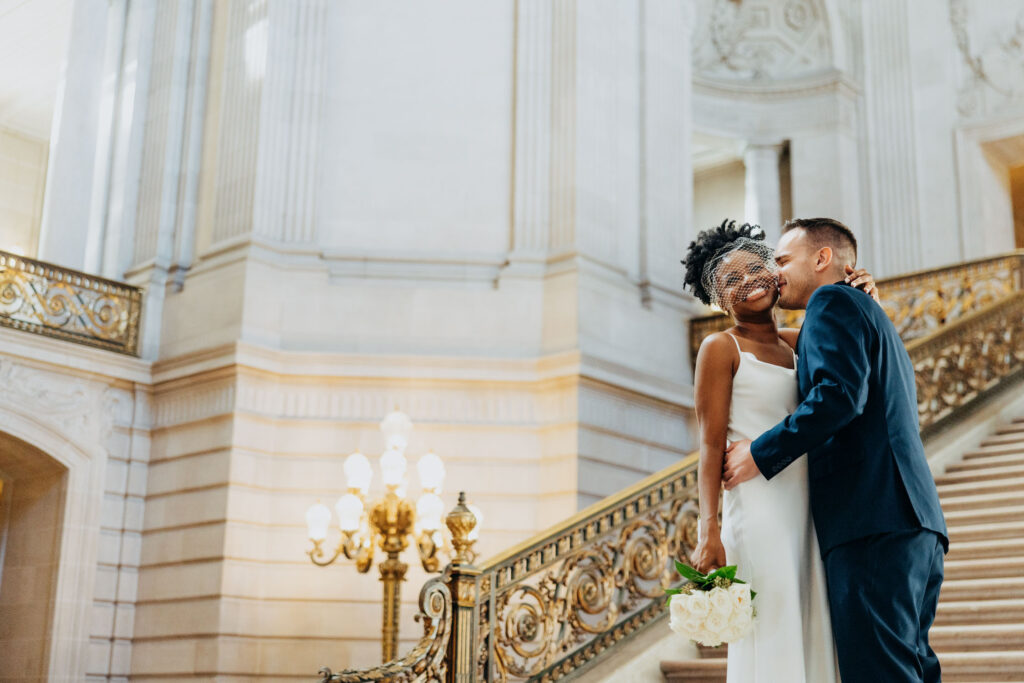 Interracial couple on grand staircase of the San Francisco City Hall 