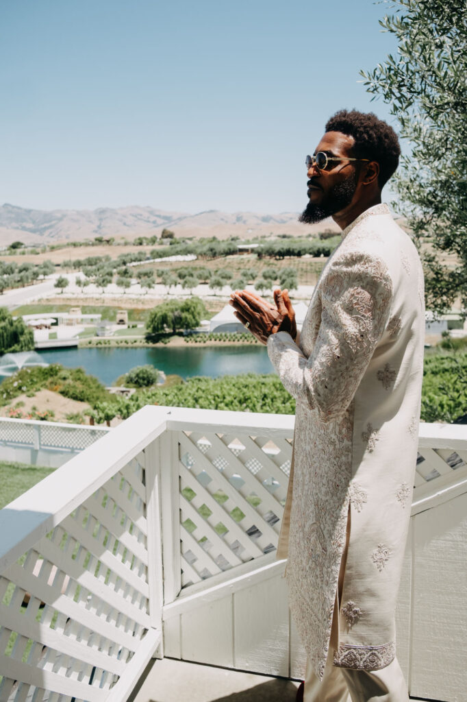 Groom getting dressed in a documentary-style portrait before his wedding at Lavanda at Leal Vineyards
