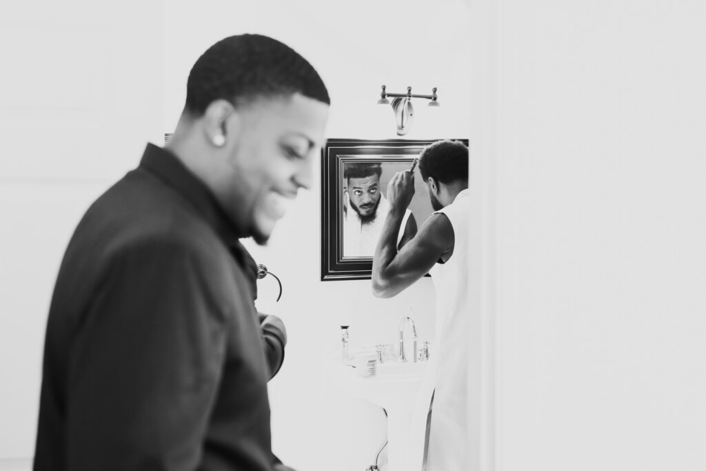 Groom getting dressed in a documentary-style portrait before his wedding at Lavanda at Leal Vineyards
