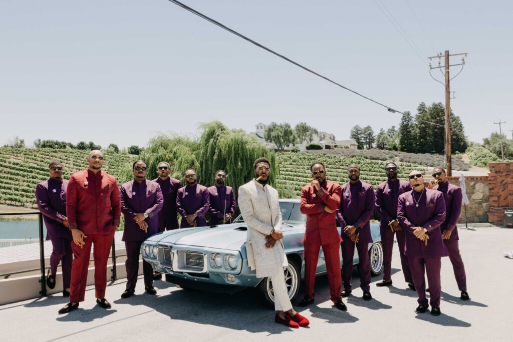 Black Groom and groomsmen posed in front of vintage blue car at Lavanda at Leal Vineyards