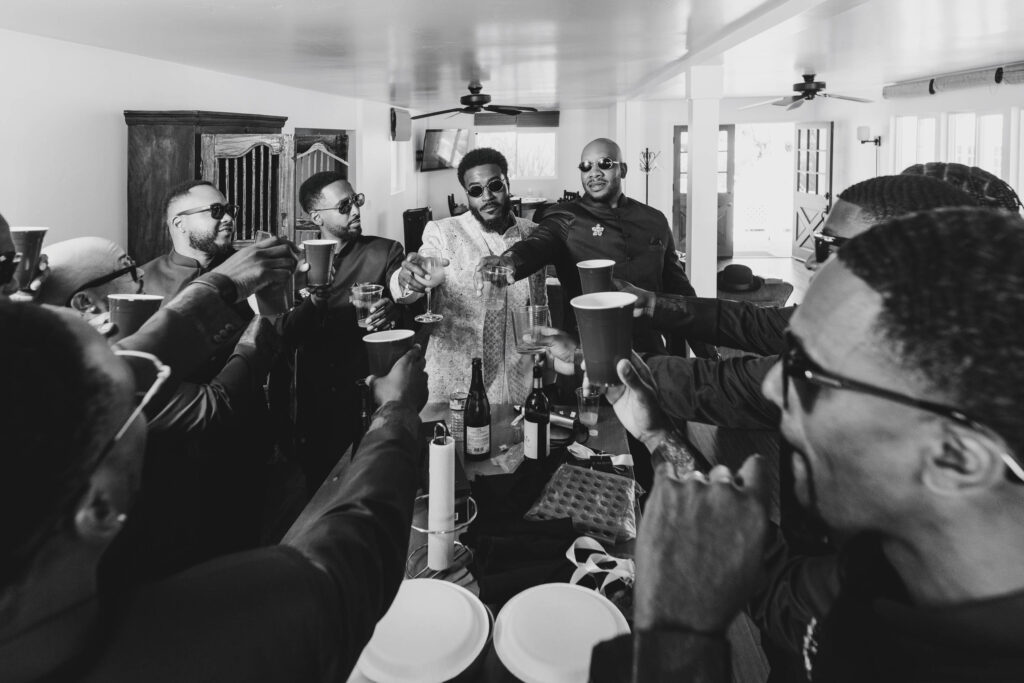 Black Groom and groomsmen toasting during getting ready at Lavanda at Leal Vineyards