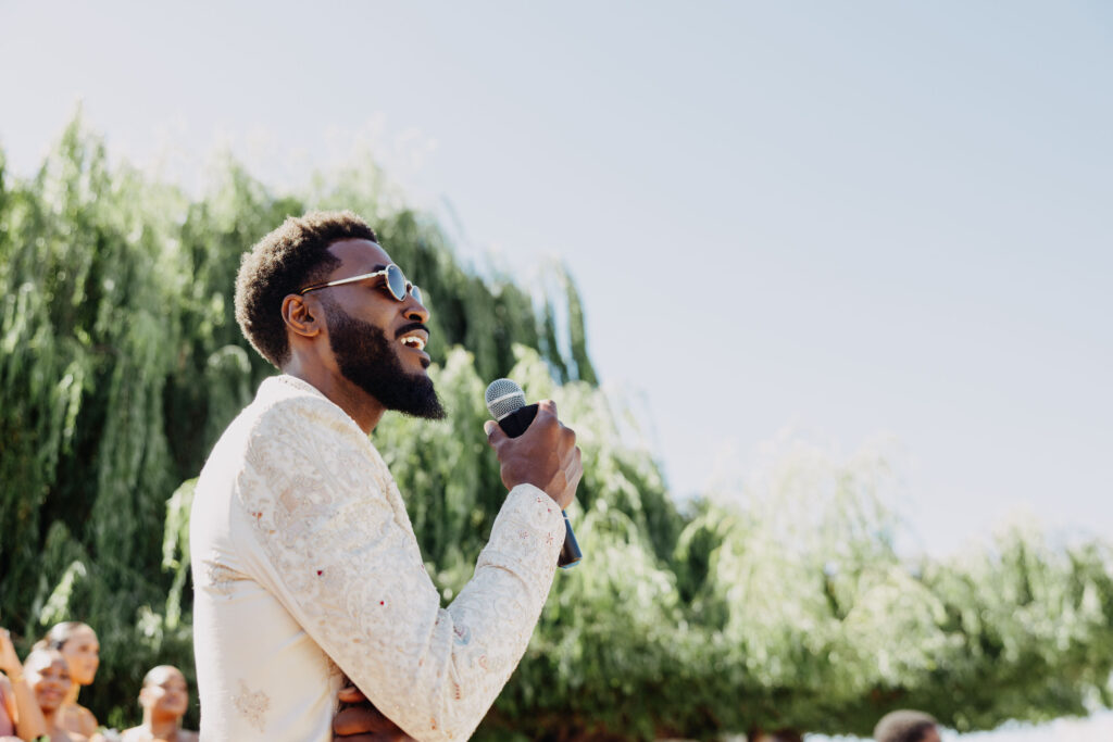 Black groom singing to his bride as she walks down the aisle at Lavanda Leal Vineyards
