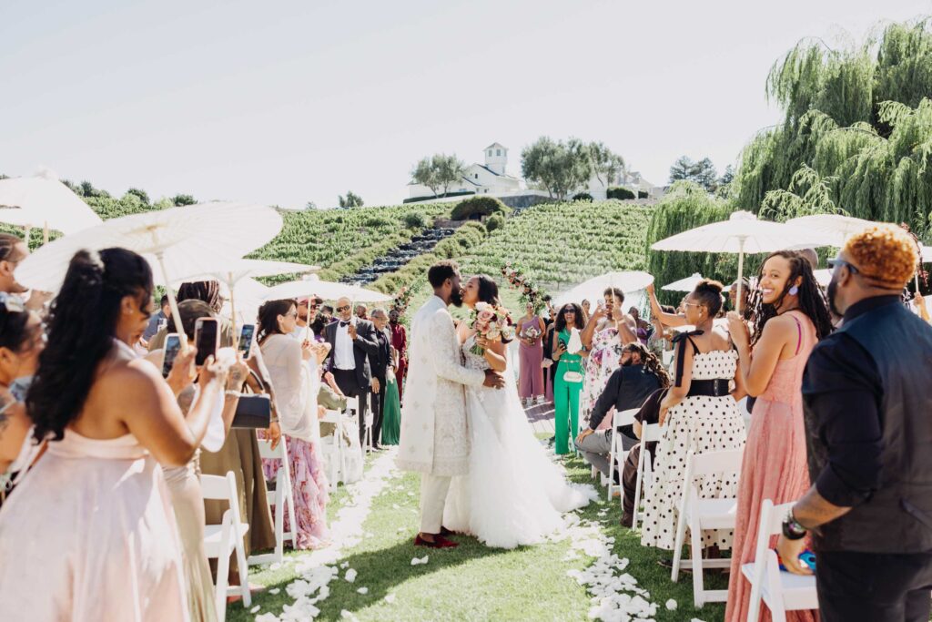 Black bride and groom sharing their first kiss as a married couple at Lavanda Leal Vineyards.
