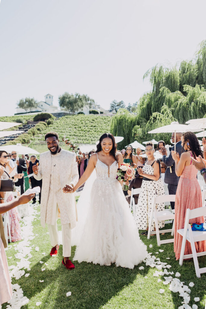 Black bride and groom walking down the aisle at their vineyard wedding at Lavanda Leal Vineyards.