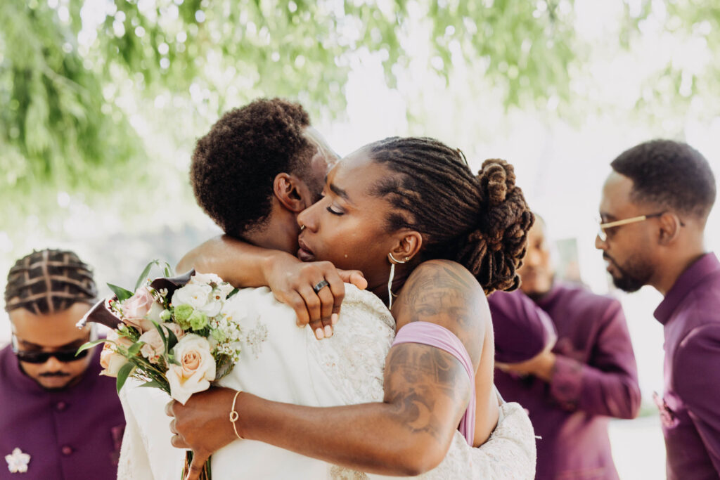 Groom and family embracing after wedding ceremony at Lavanda Leal Vineyards.