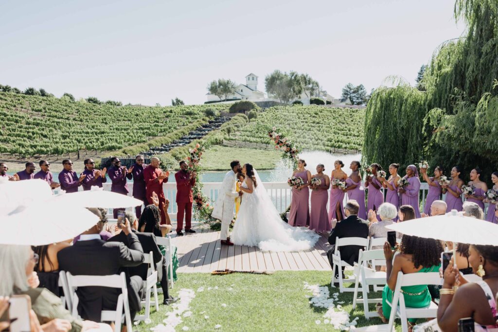 Black bride and groom sharing their first kiss as a married couple at Lavanda Leal Vineyards.