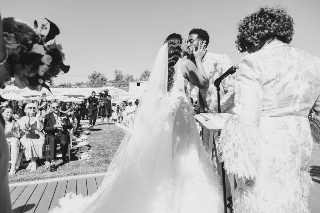 Black bride and groom sharing their first kiss as a married couple at Lavanda Leal Vineyards.