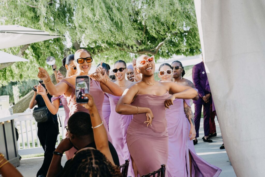 Wedding guests cheering as wedding party makes their reception entrance at Lavanda Leal Vineyards.