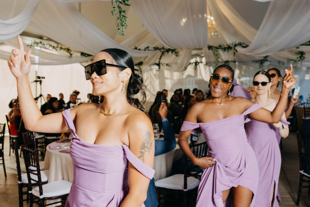 Wedding guests cheering as wedding party makes their reception entrance at Lavanda Leal Vineyards.