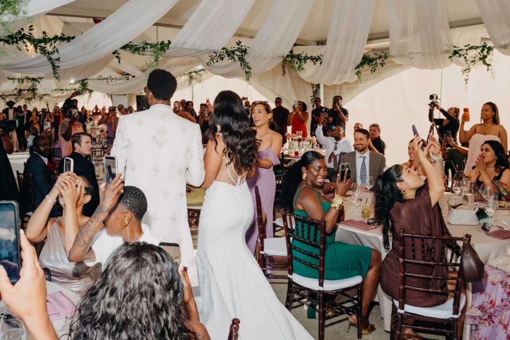 Wedding guests cheering as the newlywed Black couple makes their reception entrance at Lavanda Leal Vineyards.