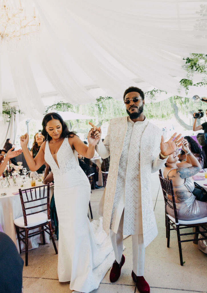 Wedding guests cheering as the newlywed Black couple makes their reception entrance at Lavanda Leal Vineyards.