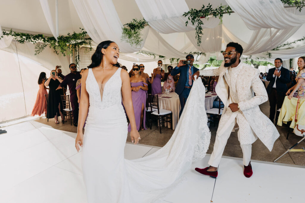 Wedding guests cheering as the newlywed Black couple makes their reception entrance at Lavanda Leal Vineyards.