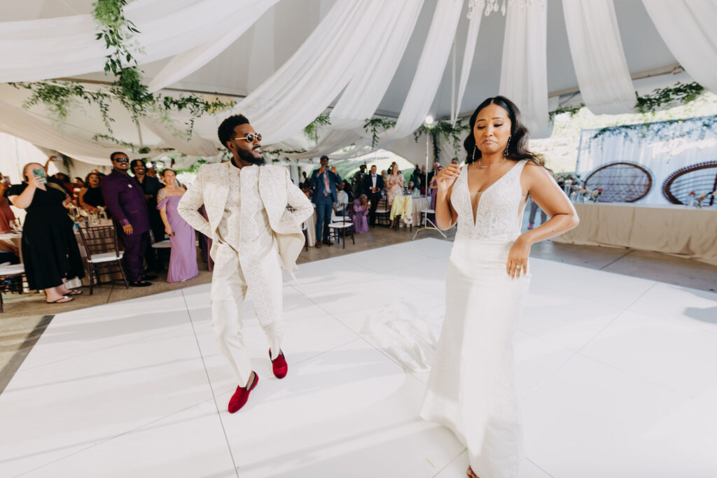 Wedding guests cheering as the newlywed Black couple makes their reception entrance at Lavanda Leal Vineyards.