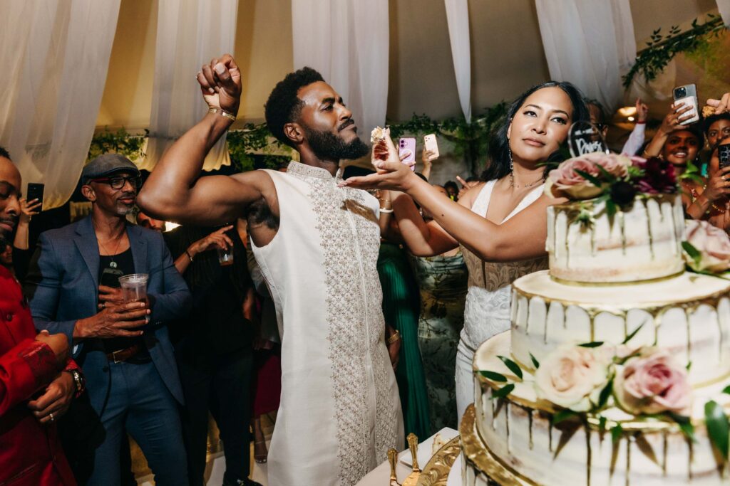 Black bride and groom cutting their wedding cake in the middle of the dance floor at Lavanda Leal Vineyards.