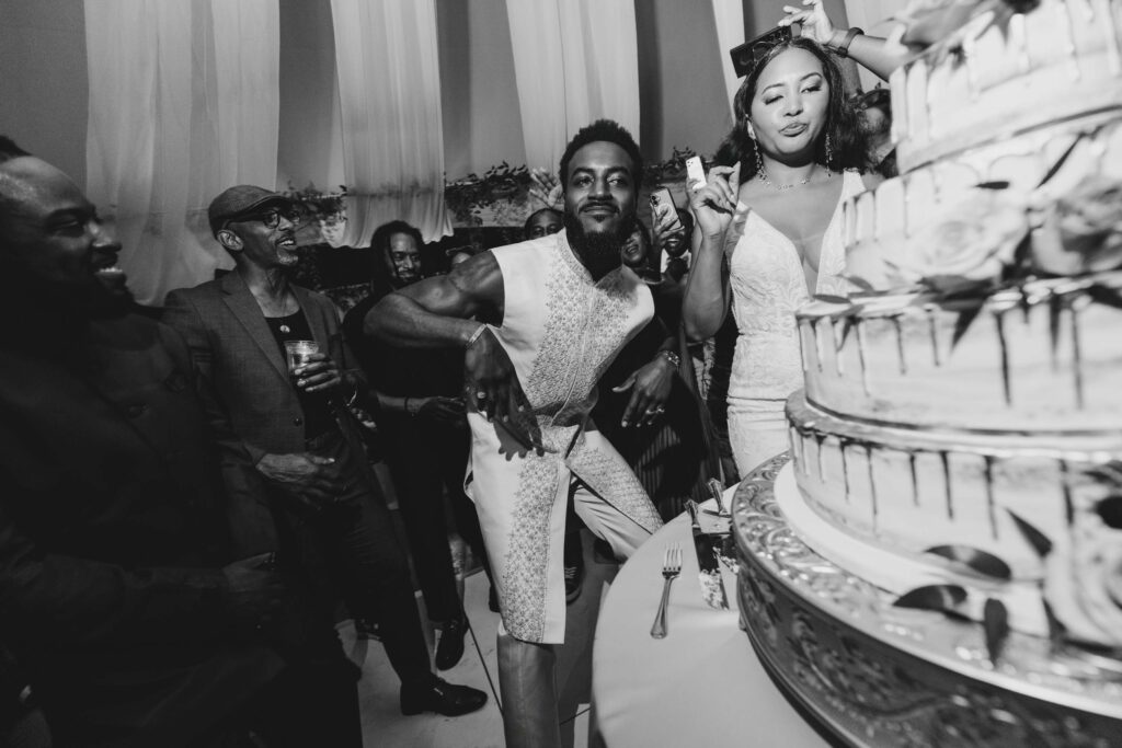 Black bride and groom cutting their wedding cake in the middle of the dance floor at Lavanda Leal Vineyards.