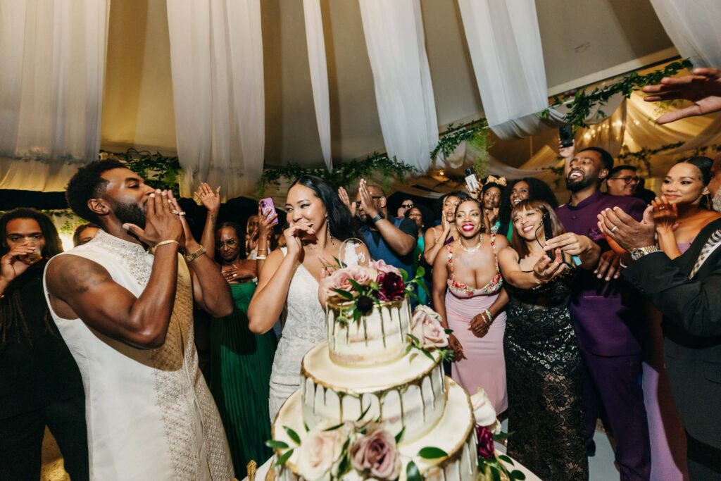 Black bride and groom cutting their wedding cake in the middle of the dance floor at Lavanda Leal Vineyards.